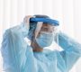 side view woman doctor putting protective wear 90x80